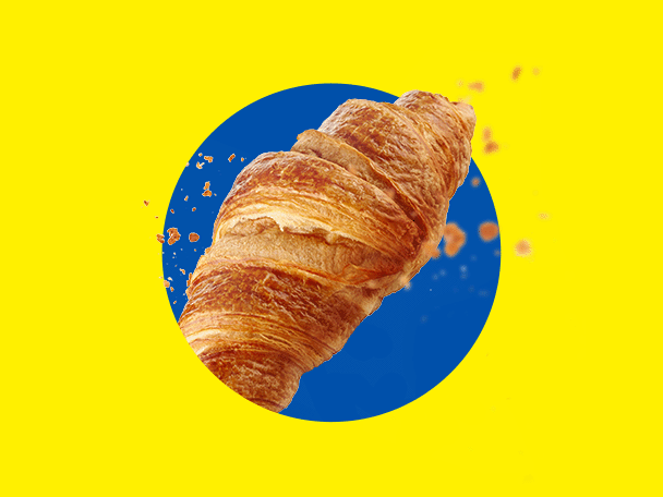 Aranybarna, ropogós croissant sárga háttéren kék körrel.