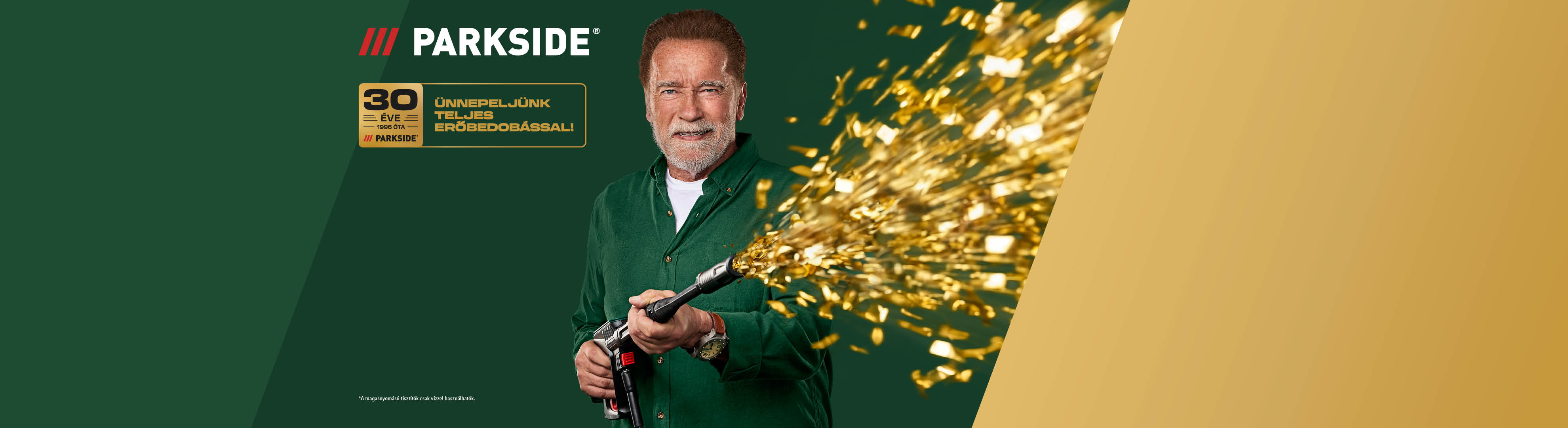 Arnold Schwarzenegger egy konfettilövővel ünnepli a 30 éves évfordulót, arany konfettivel.