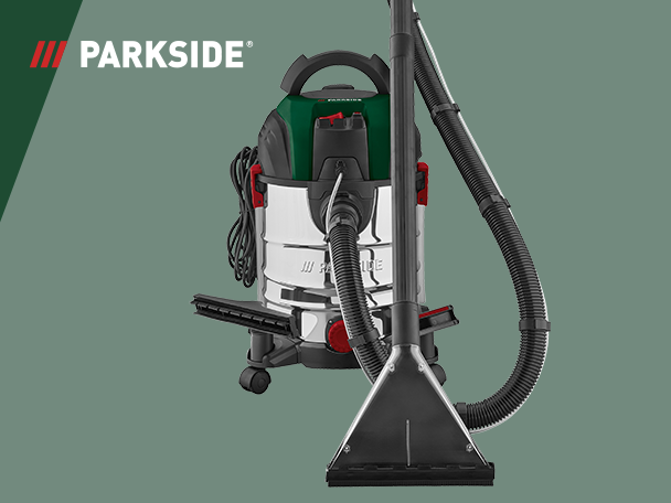 Ipari porszívó és kárpittisztító gép, zöld és ezüst színben, fekete tömlővel és szívófejjel.