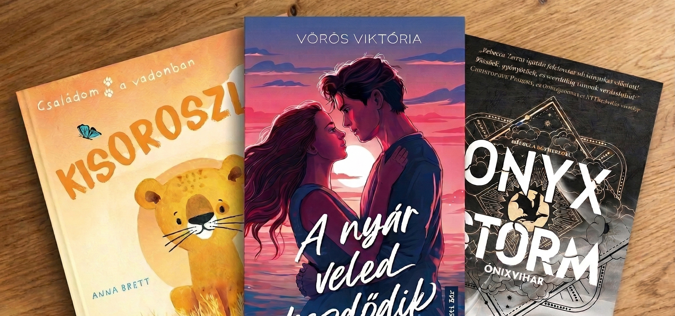 Négy könyv fekszik egy fa felületen, különböző borítókkal és témákkal.