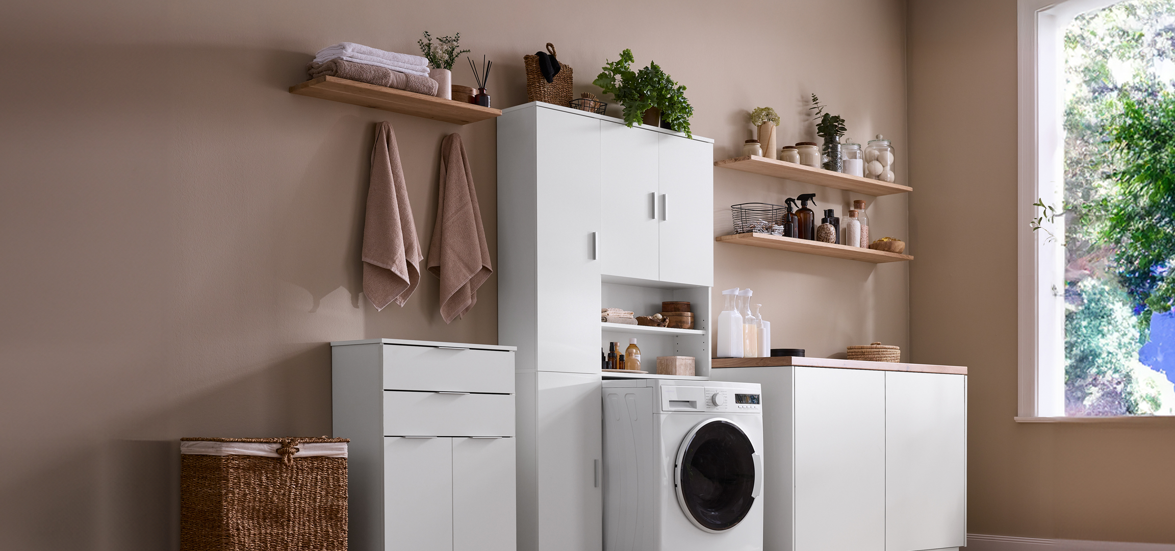 Mosókonyha mosógéppel, szárítóval, tárolókkal és polcokkal.